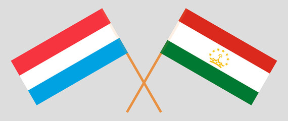 Crossed flags of Luxembourg and Tajikistan. Official colors. Correct proportion