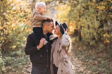 Family with a little son in autumn park