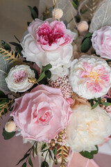 Flowers arrangement in interior in table. Preserved fresh flowers bouquet closeup. Eternal, stabilized, forever rose flower.