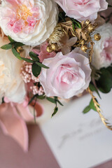 Flowers arrangement in interior in table. Preserved fresh flowers bouquet closeup. Eternal, stabilized, forever rose flower.