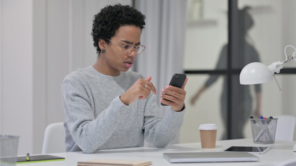 African Woman having Loss while using Smartphone 