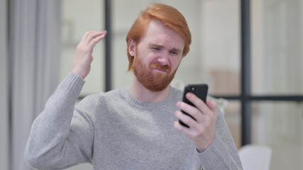 Young Beard Redhead Man Loss on Smartphone