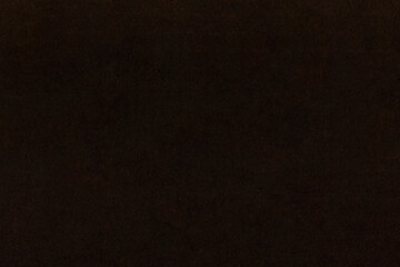 Dark non-uniform paper with spots and inclusions.
