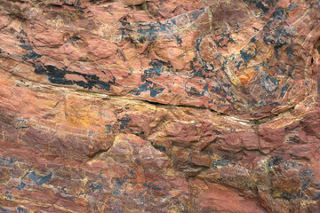 Granite texture. Red stone in detail. Natural background chipping rocks.