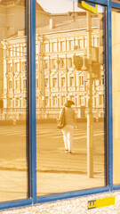 Woman reflections in the windows of buildings in the city