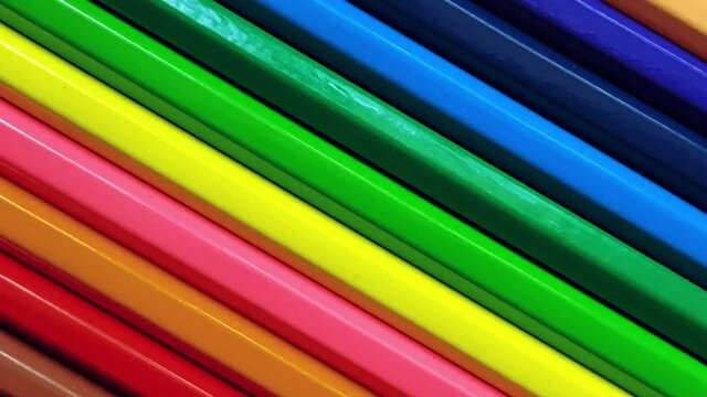 Colored pencils revolve around the axis close-up. Creative video, education concept