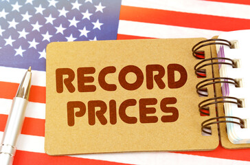 On the US flag lies a notebook with the inscription - Record prices