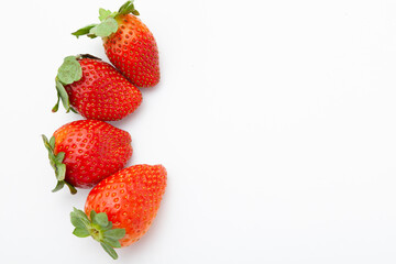  four strawberries on a white