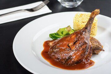 Braised lamb shank on the mashed potato on wooden table