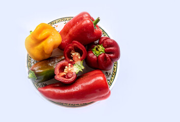 Bell pepper on a plate. The background is white, there is free space for insertion.