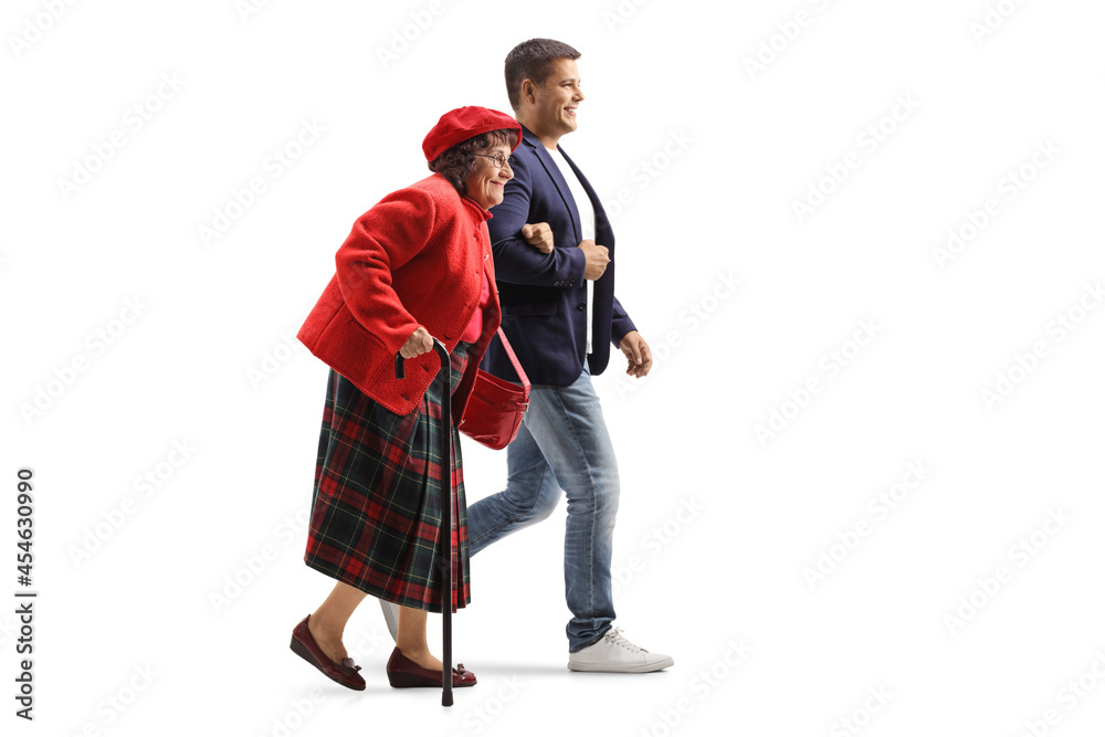 Wall mural Full length profile shot of a young man helping an elderly woman walking