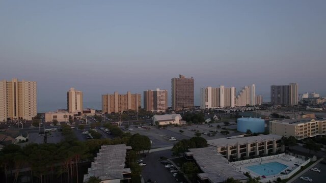 Drone moving towards Ocean City MD sky rise during sun set