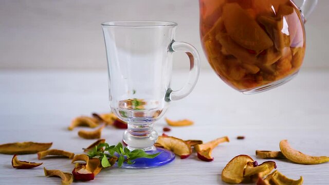 sweet cool compote boiled from various dried fruits, in a glass decanter on the table