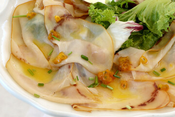 Plate of swordfish carpaccio marinated with prickly pear