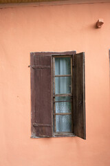 Old style window made of wood on old wall