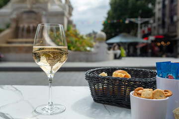 Drinking of brut champagne sparkling wine in street cafe in old central part of city Reims, Champagne, France