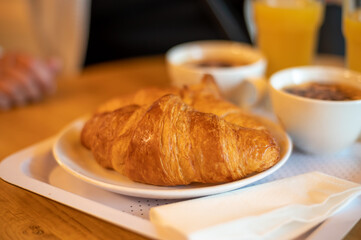 French breakfast with fresh baked croissants, coffee and orange juice