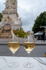 Drinking of brut champagne sparkling wine in street cafe in old central part of city Reims, Champagne, France