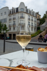 Drinking of brut champagne sparkling wine in street cafe in old central part of city Reims, Champagne, France