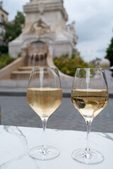 Drinking of brut champagne sparkling wine in street cafe in old central part of city Reims, Champagne, France