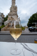 Drinking of brut champagne sparkling wine in street cafe in old central part of city Reims, Champagne, France