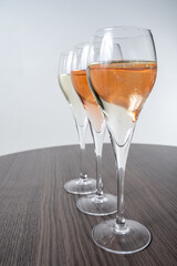 Tasting of white and rose champagne sparkling wine from flute glasses