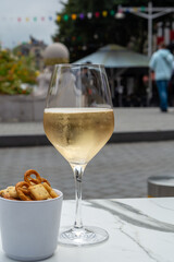 Drinking of brut champagne sparkling wine in street cafe in old central part of city Reims, Champagne, France