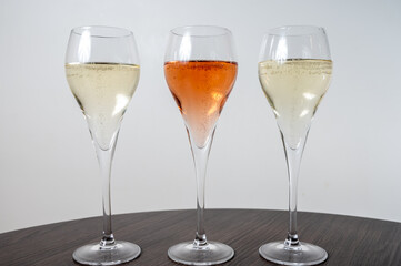 Tasting of white and rose champagne sparkling wine from flute glasses