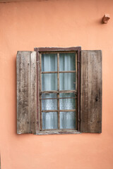 Old style window made of wood on old wall