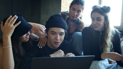 Group of teenagers searching for information online via laptop 