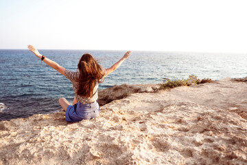 person with raised hands in the nature landscape scene, feeling happy and free