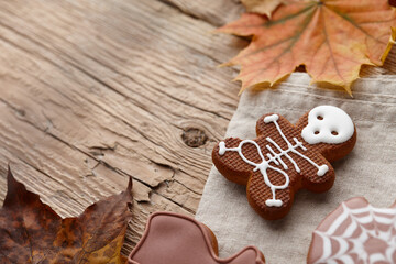 Halloween gingerbread cookies and autumn leaves background