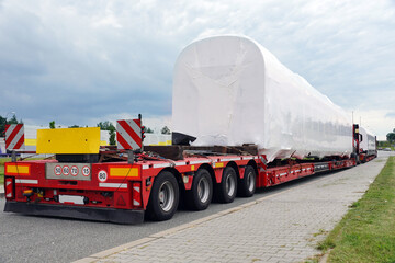 Very long vehicle. Oversize load or exceptional convoy. A truck with a special semi-trailer for...
