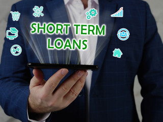  SHORT TERM LOANS text in search line. Manager looking for something at computer. SHORT TERM LOANS...