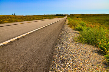 Quiet two lane road leading into peaceful countryside of rural America.