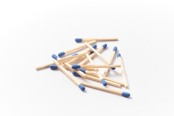 Matches on a white background, pile of phosphorus blue head matchsticks isolated. Used for a barbecue ignite or kitchen household