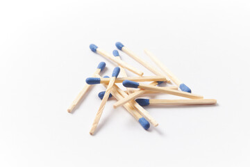 Matches on a white background, pile of phosphorus blue head matchsticks isolated. Used for a barbecue ignite or kitchen household
