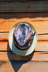 The hat is hanging on the wall