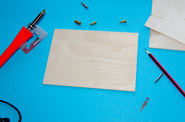 A pyrography tool on a blue background.selective focus
