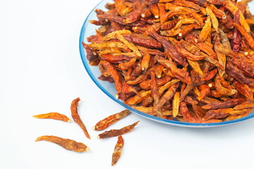 dried chili on plate on white background.