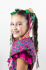 Brazilian little girl dressed for June party carnival  são João  happy and excited in studio with white background