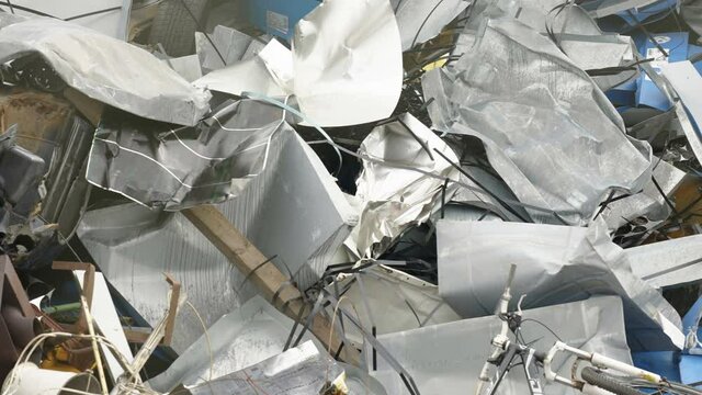 The crumpled metal sheets on the heap of trash in the dumping site in Estonia
