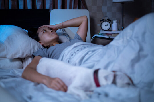 Depressed Asian woman can not sleep on the bed.Insomnia syndrome sleepless after unhappy