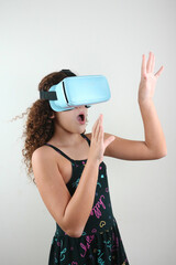 girl from the future with vr glasses traveling in the virtual world playing a game in the studio...