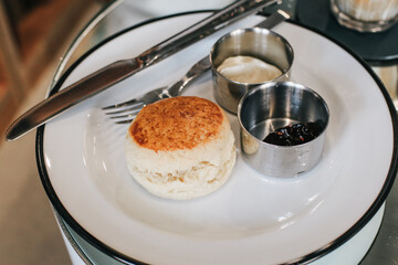 Butter scones with strawberry Jam and Clotted Cream on the table. Traditional English afternoon tea...