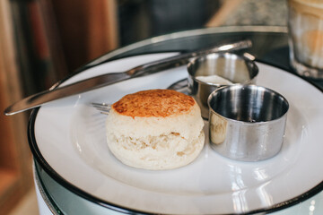 Butter scones with strawberry Jam and Clotted Cream on the table. Traditional English afternoon tea horizontal.