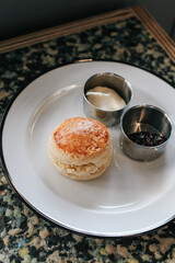 Butter scones with strawberry Jam and Clotted Cream on the table. Traditional English afternoon tea horizontal.