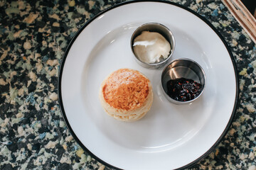 Butter scones with strawberry Jam and Clotted Cream on the table. Traditional English afternoon tea horizontal.
