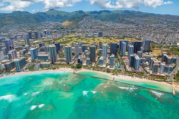 Aerial view of Waikiki Beach, Oahu, Hawaii. Turquoise blue water bordered by golden sandy beaches and hotels.  