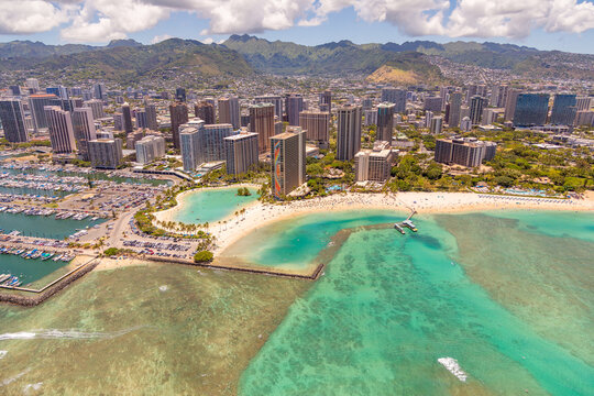 Aerial view of Waikiki Beach, Oahu, Hawaii. Turquoise blue water bordered by golden sandy beaches and hotels.  